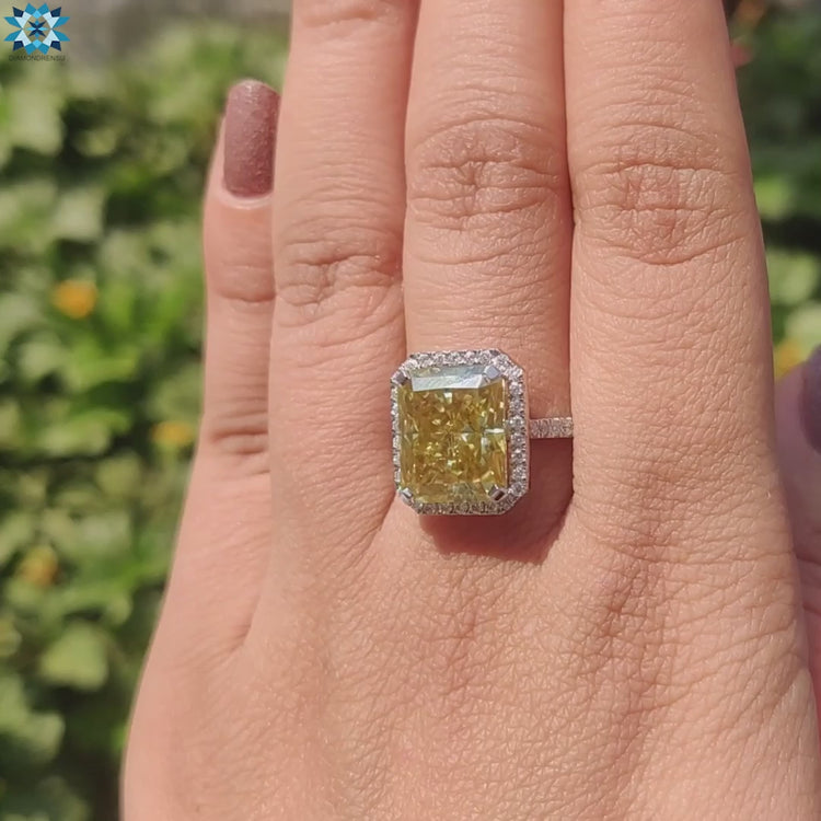 Radiant cut engagement ring with white gold and halo detail.
