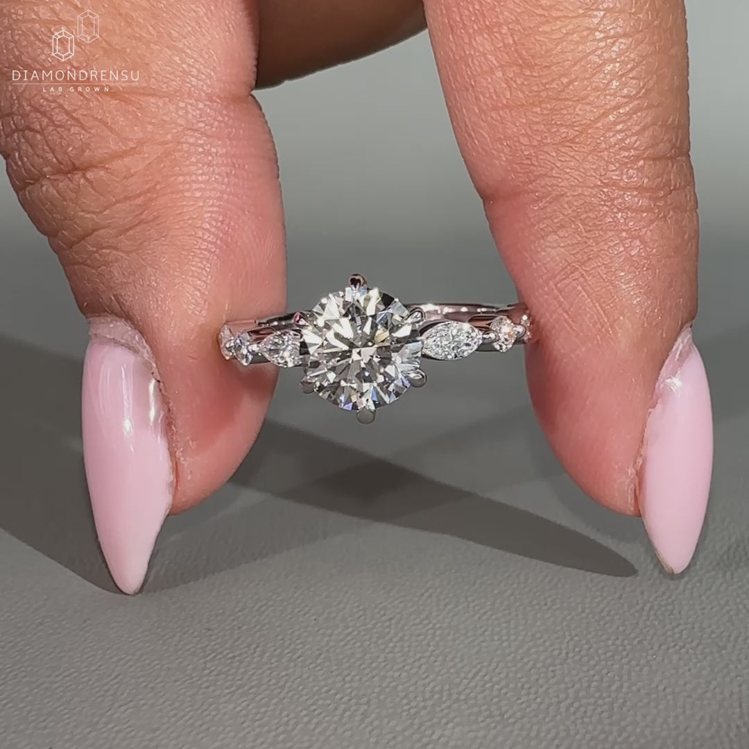 White gold diamond ring featuring shared prong setting and custom design.
