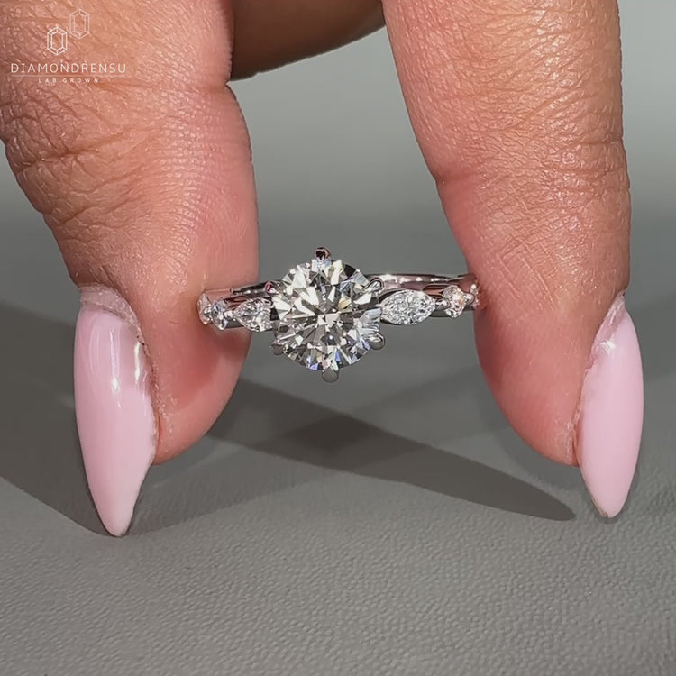 White gold diamond ring featuring shared prong setting and custom design.
