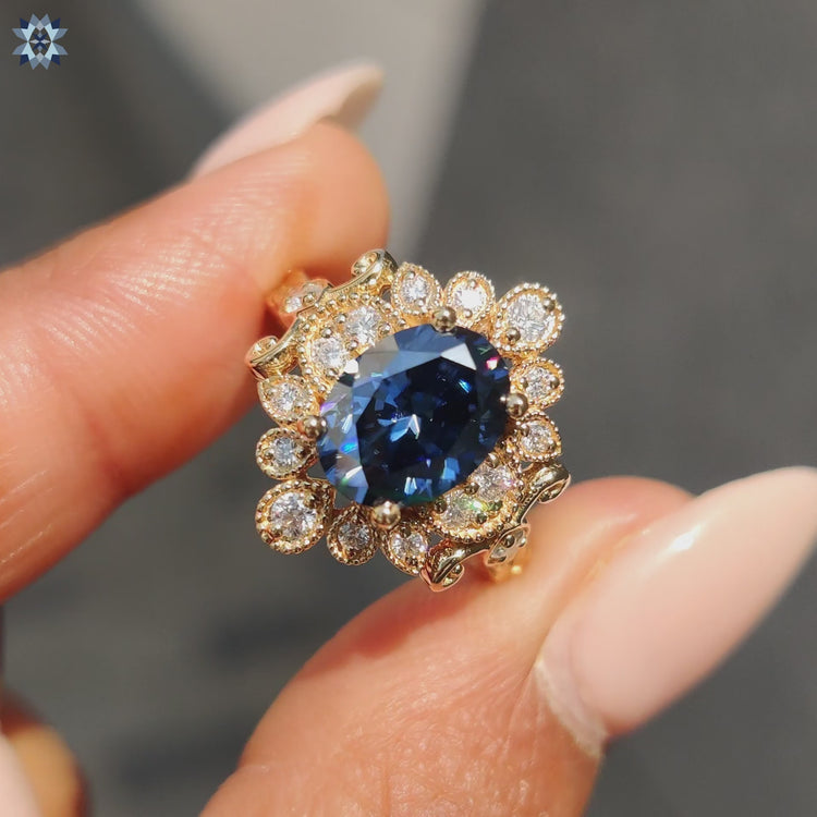 Blue moissanite ring set in a round cut halo design.
