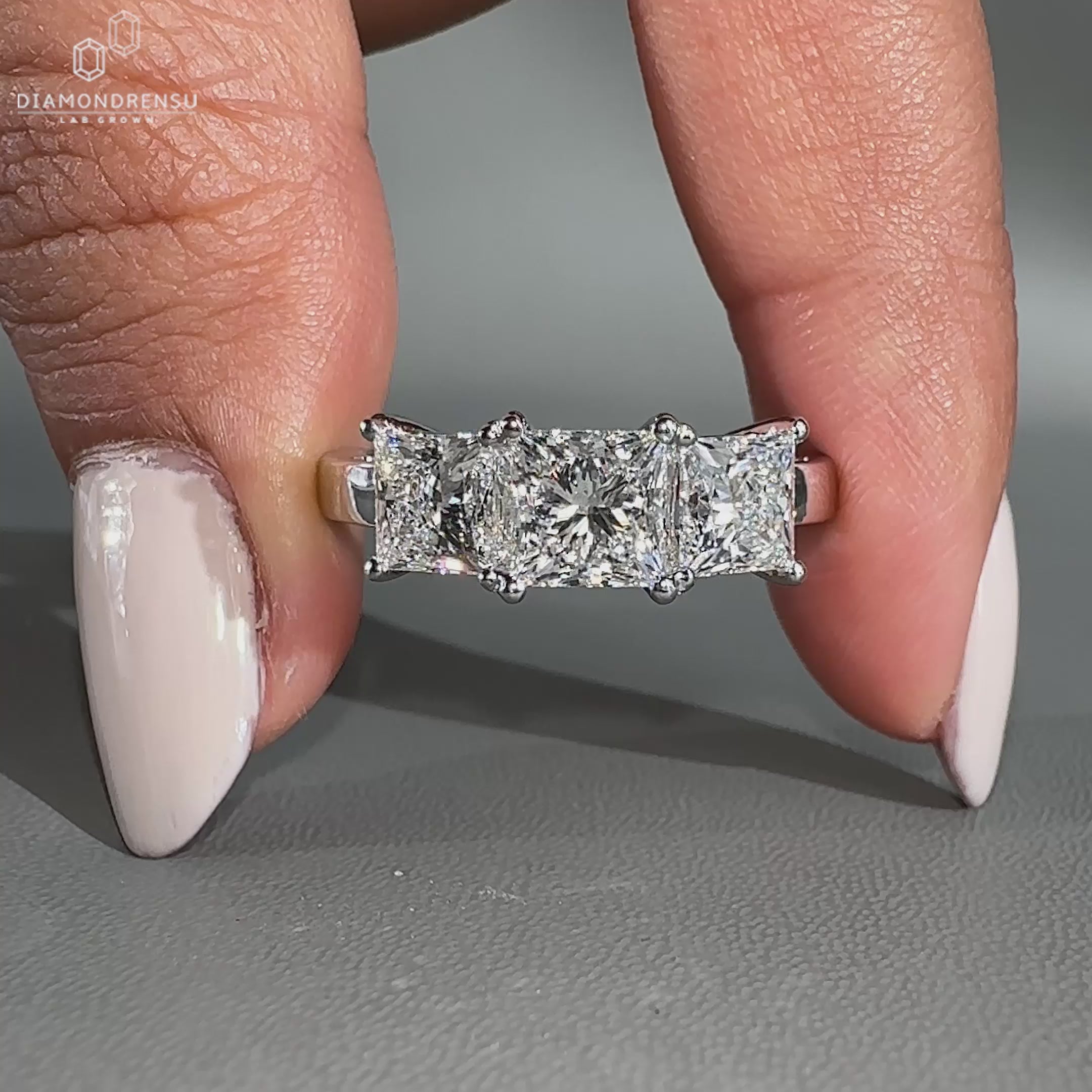 3 stone engagement ring with white gold band and prong setting
