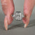 It has 2 trillion side stones with a bezel set engagement ring style.
