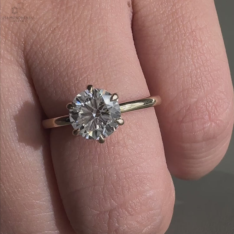 Round cut diamond ring as a unique diamondrensu UK engagement piece.