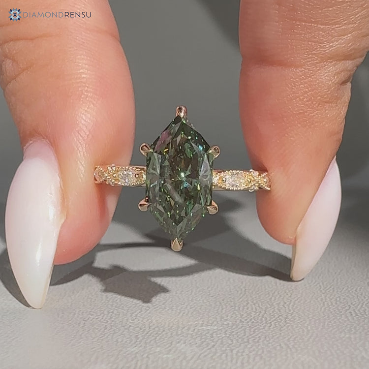 Green Dutch marquise diamond ring with round side stones.