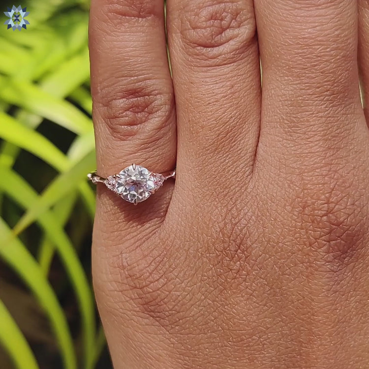 Moissanite engagement ring crafted with side stones and claw setting.
