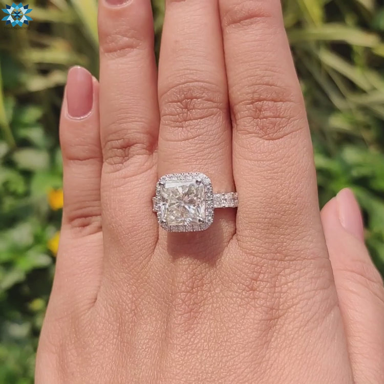 Handmade radiant cut ring in white gold with custom pave setting.
