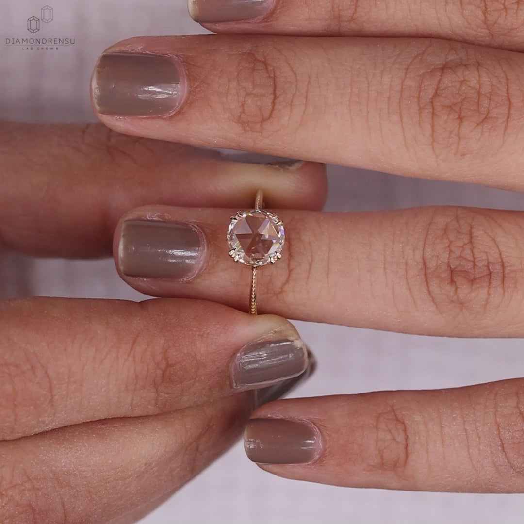Round rose cut diamond solitaire ring with double claw prong setting.
