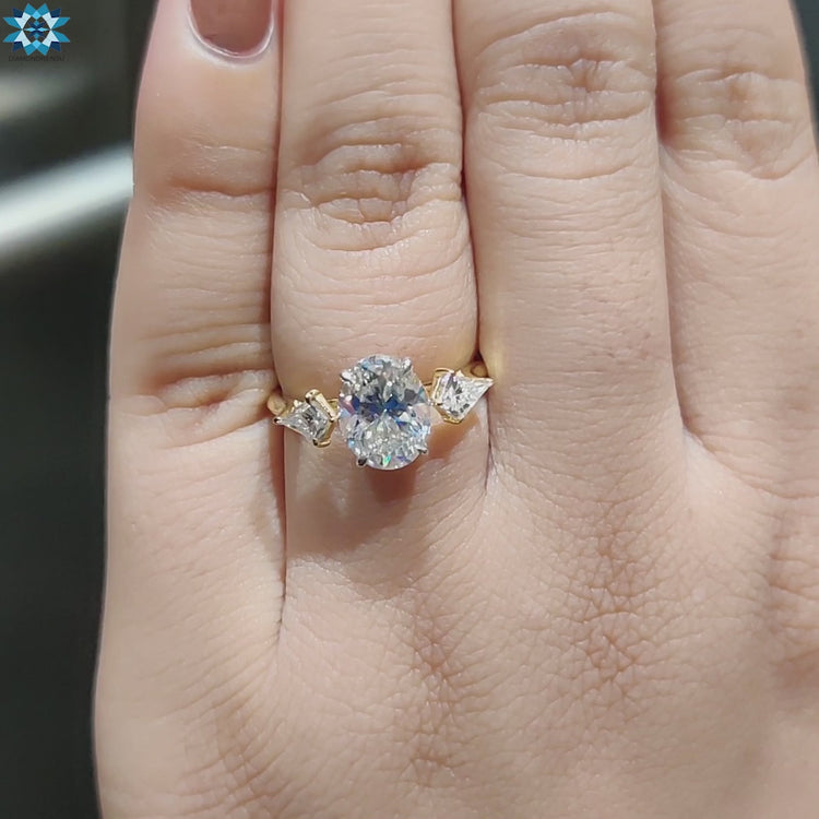 Yellow gold custom engagement ring with three stones.
