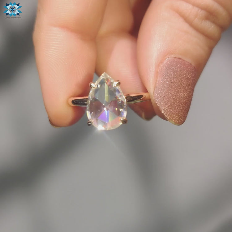 Prong setting ring with 4 claw prongs and pear moissanite.

