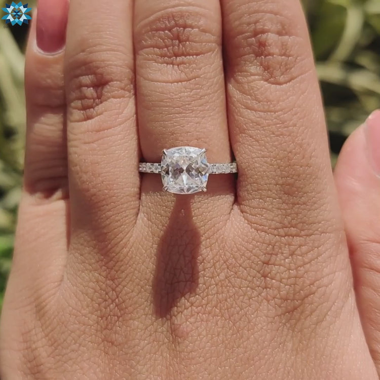 Cushion divine cut ring with pave band.
