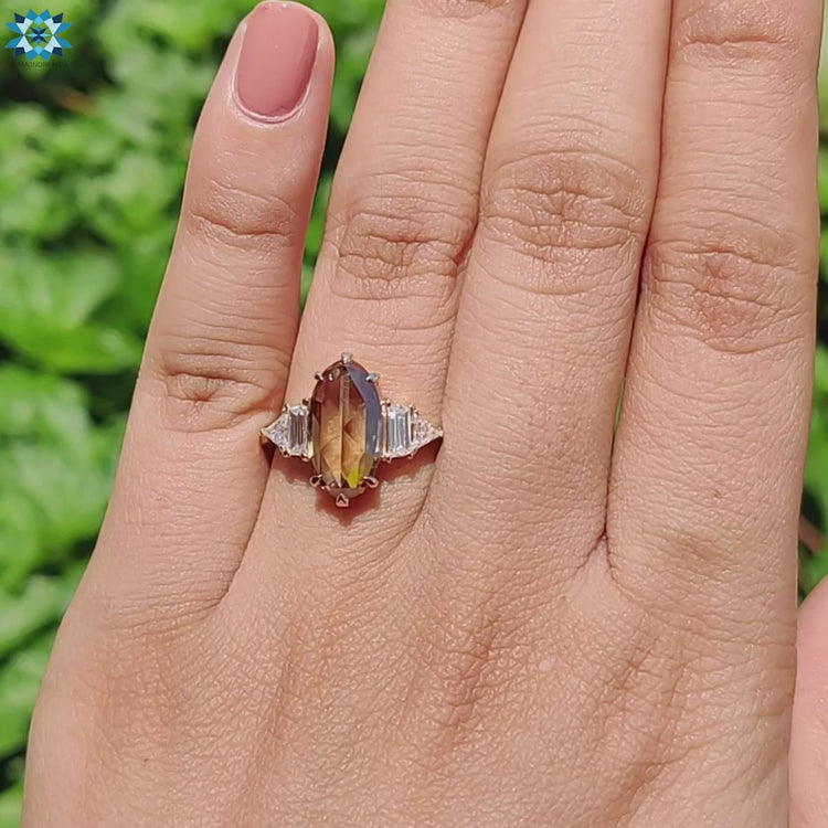 Yellow gold setting with geometric side stones.
