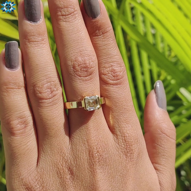 Yellow gold ring with half bezel set Asscher stone.
