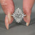 Prong setting ring featuring round cut halo design.
