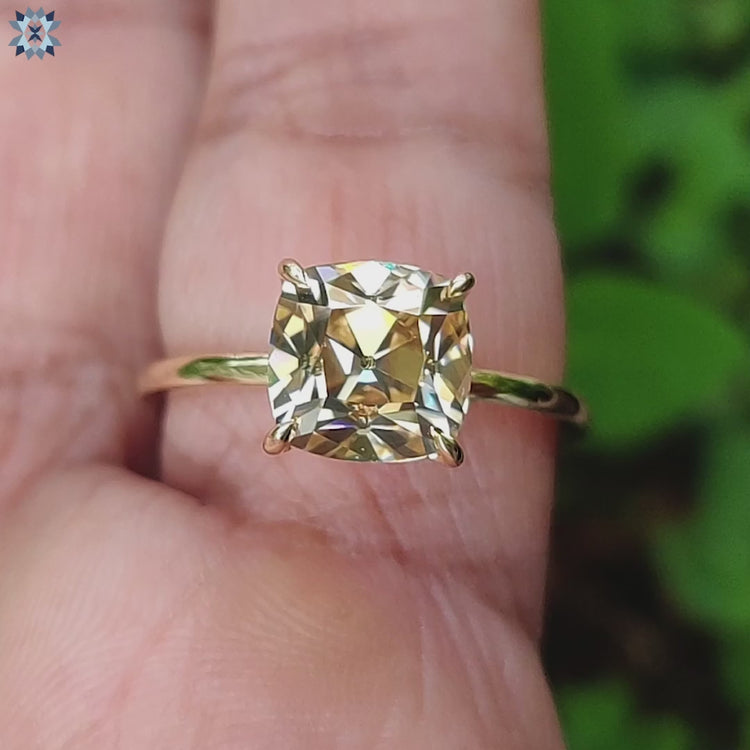 Yellow gold ring with old European cushion moissanite.
