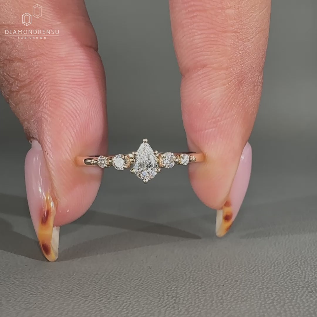 Yellow gold 5 stone engagement ring with teardrop diamond