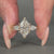 Handmade three diamond ring with pear side stones.