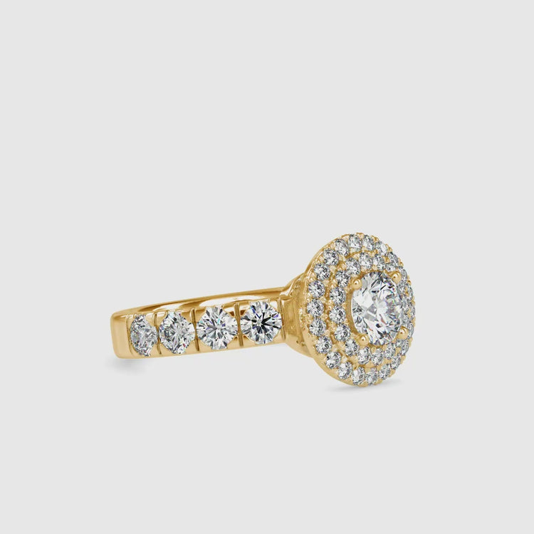 Rose gold halo engagement ring with round centre and four prong setting.