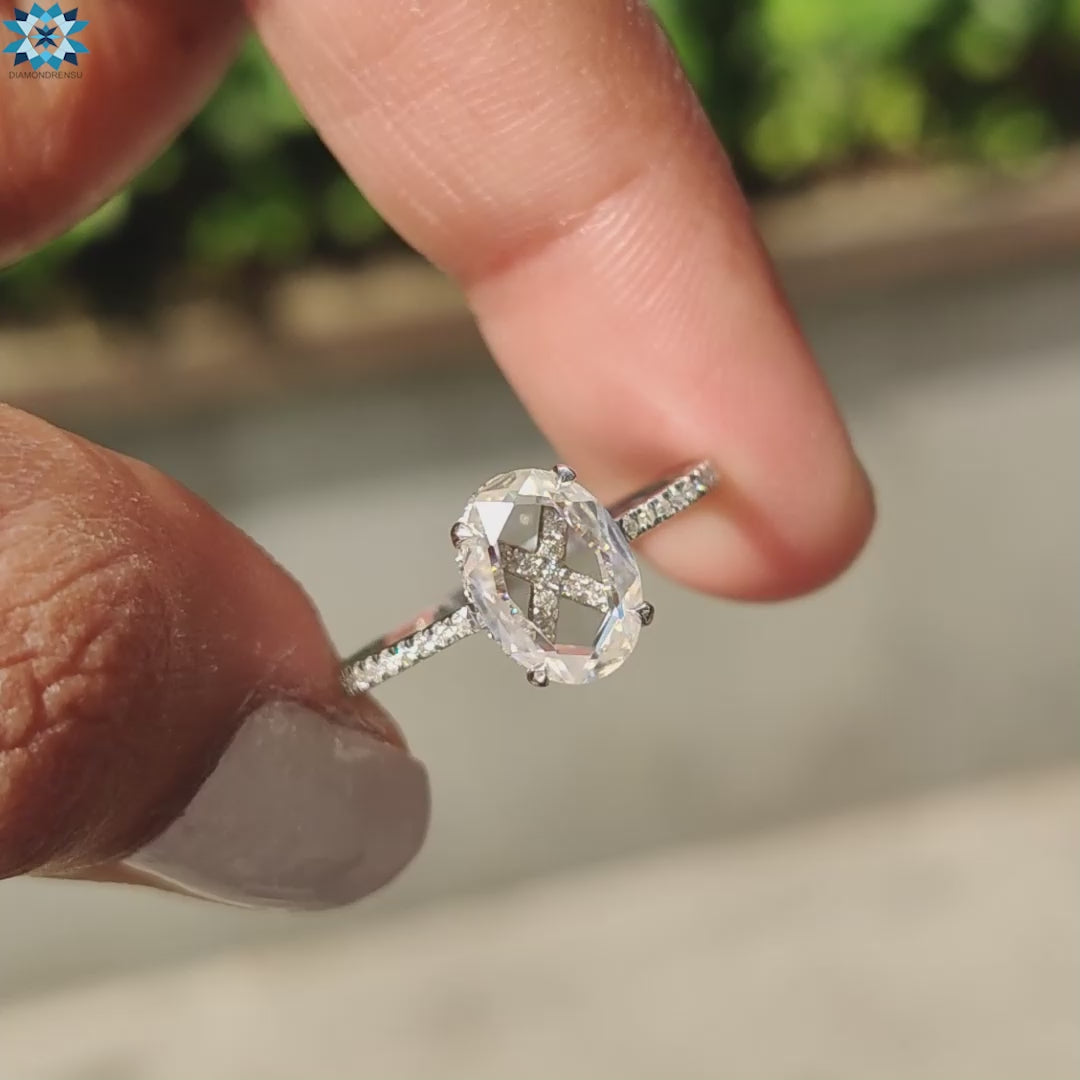 White gold engagement ring featuring oval rose cut and round pave band.
