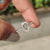 White gold engagement ring featuring oval rose cut and round pave band.
