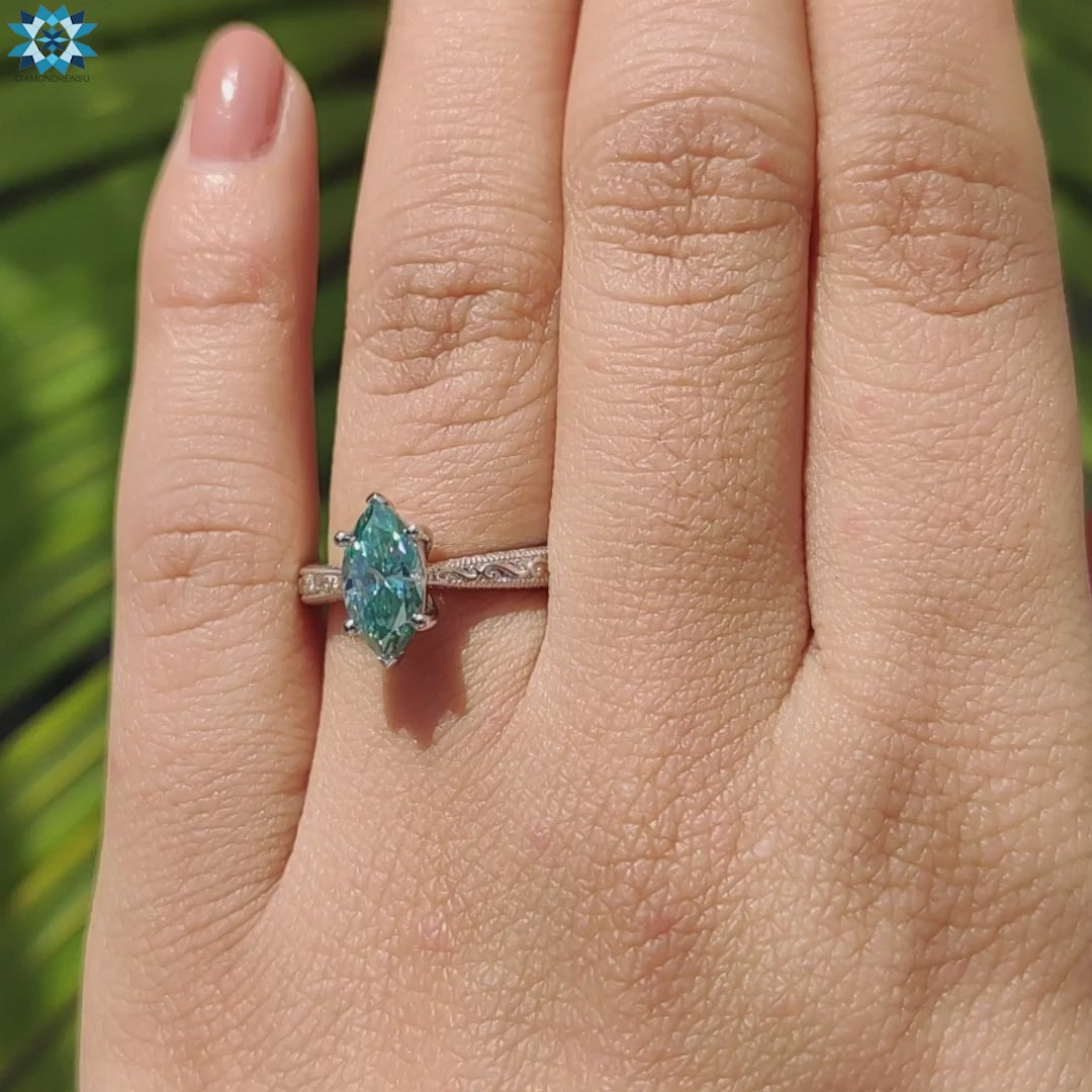 Cyan blue marquise cut moissanite solitaire ring with vintage milgrain detailing.
