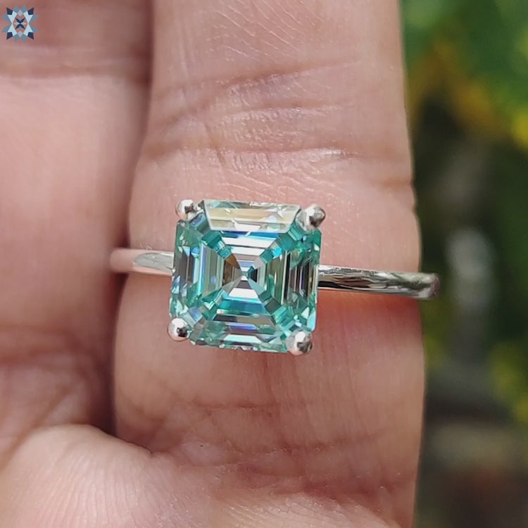Asscher cut solitaire ring with moissanite in white gold.
