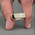 Custom gold signet ring for men featuring two round cut diamonds.
