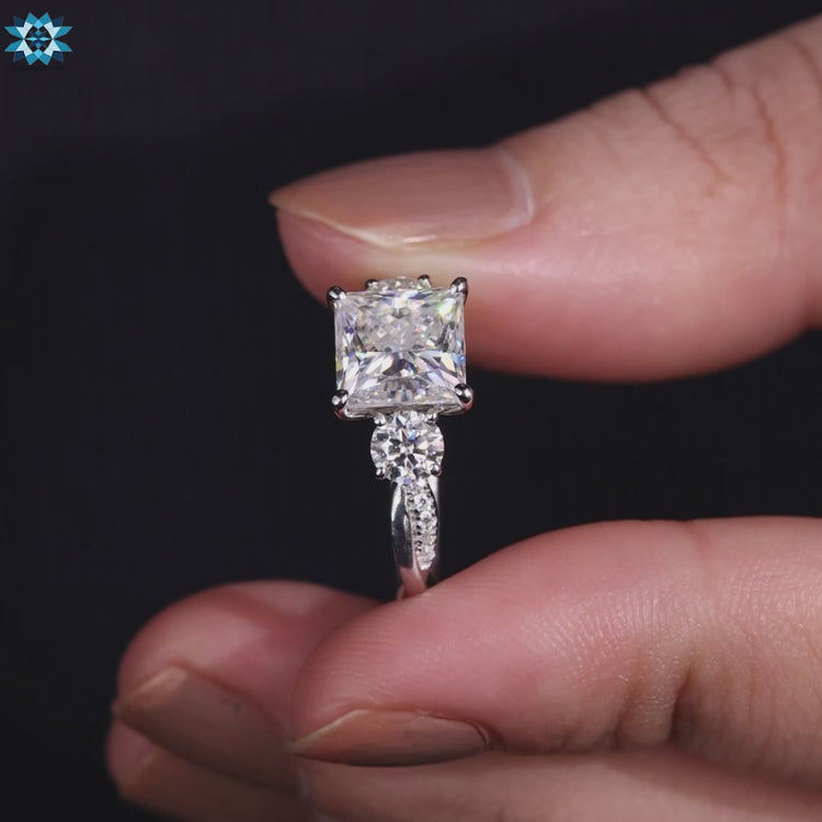 Moissanite engagement ring with round side stones.
