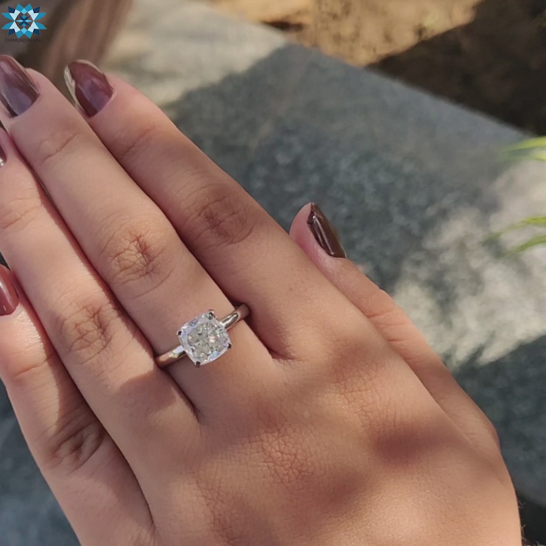 Elegant cushion cut moissanite ring with a 4 prong engagement ring setting, perfect for a unique proposal.