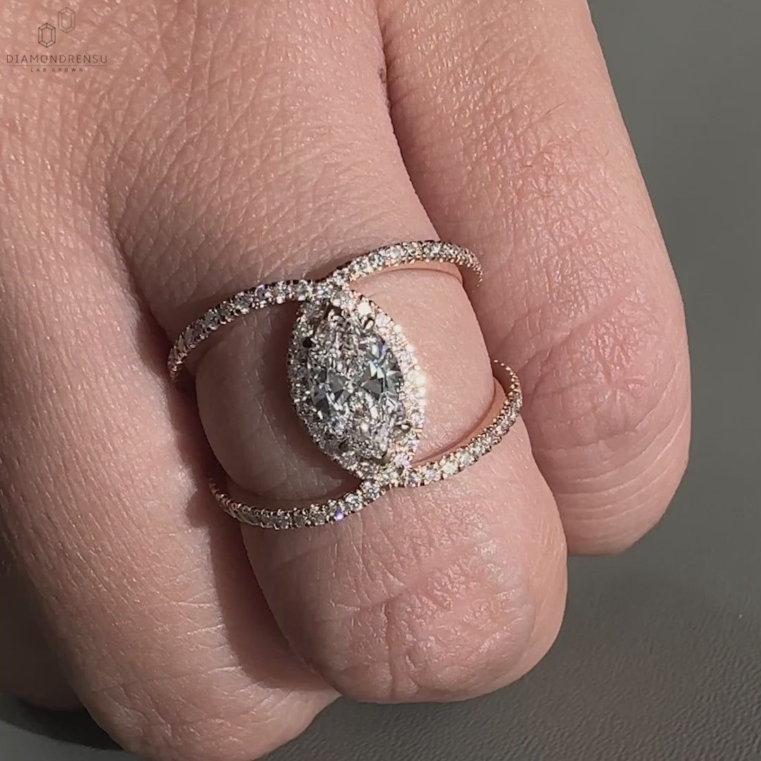 Rose gold diamond ring featuring a marquise cut diamond with a pave ring design.
