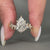 Pear cut diamond ring with marquise and round diamond details.