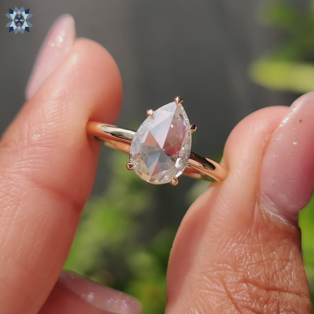 Handmade yellow gold engagement ring with pear rose cut Moissanite solitaire.
