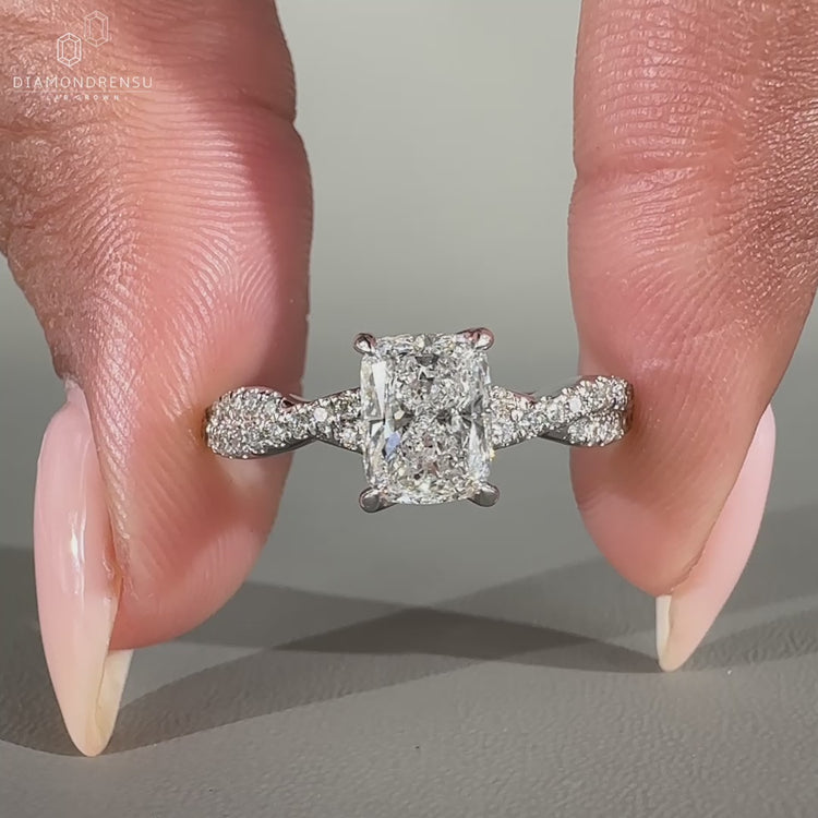 White gold engagement ring with twisted pave band