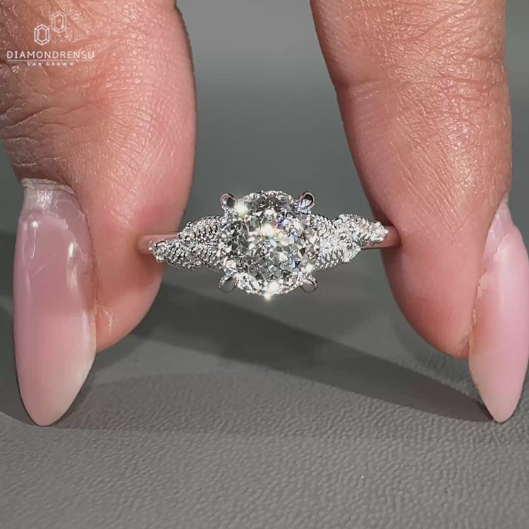 Portuguese cut center diamond ring with four claw prong set design.
