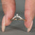 Pear and round diamond band in a curved yellow gold design.