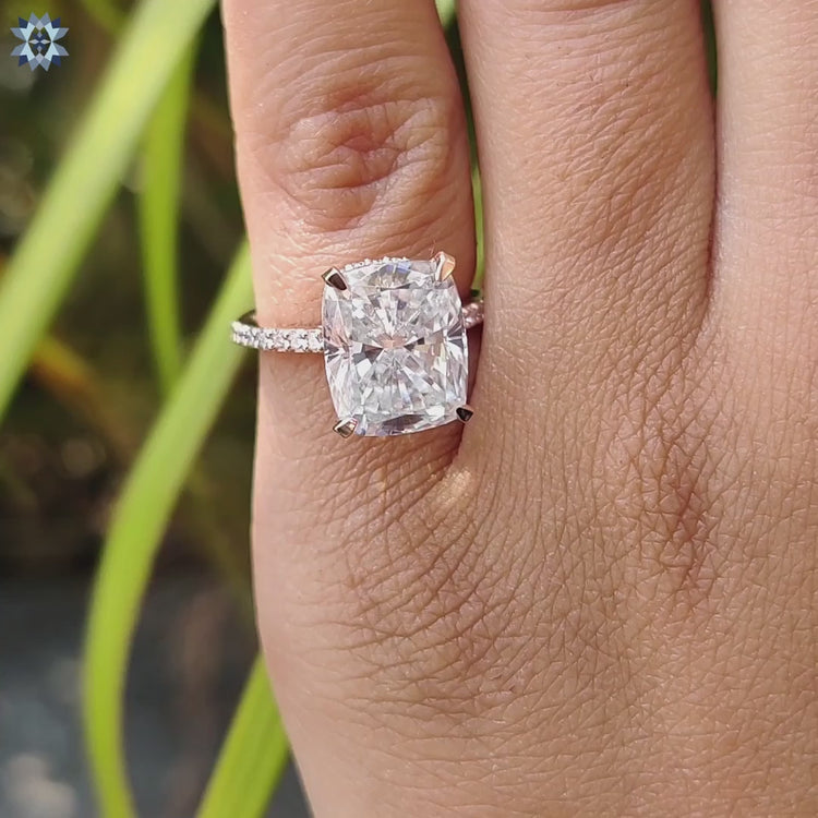 White and rose gold ring featuring cushion moissanite.
