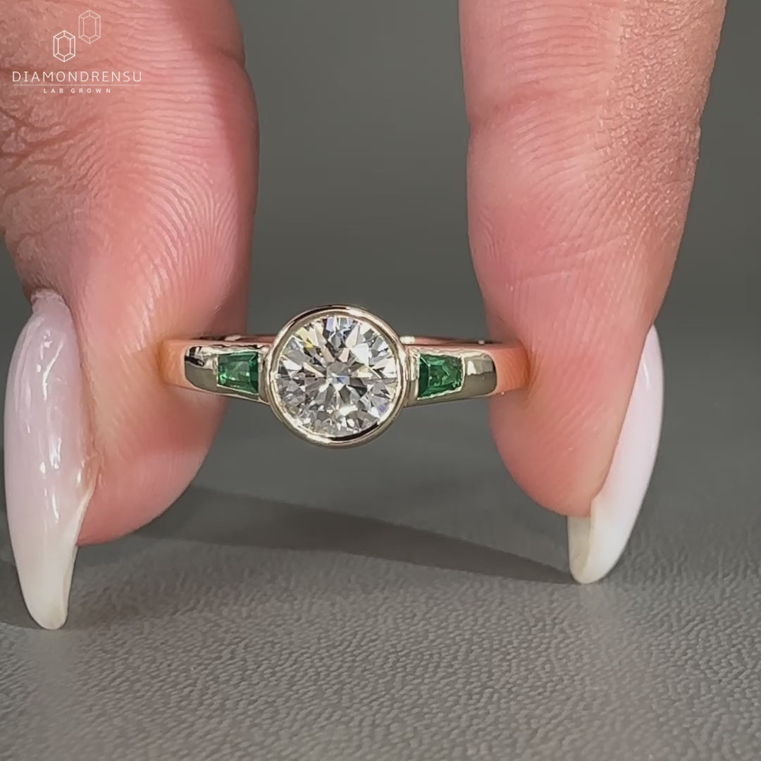 Bezel setting added to three stone diamond ring design.