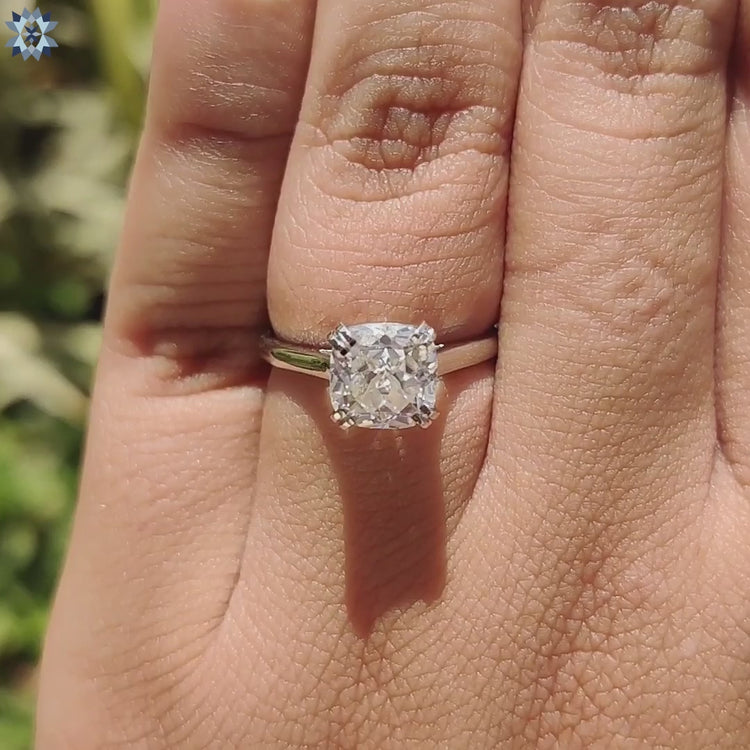 Unique cathedral setting ring with cushion shaped moissanite.
