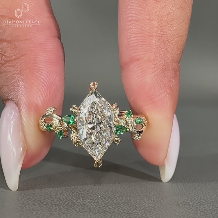Side Stone Emerald Marquise Diamond placed beside center stone.