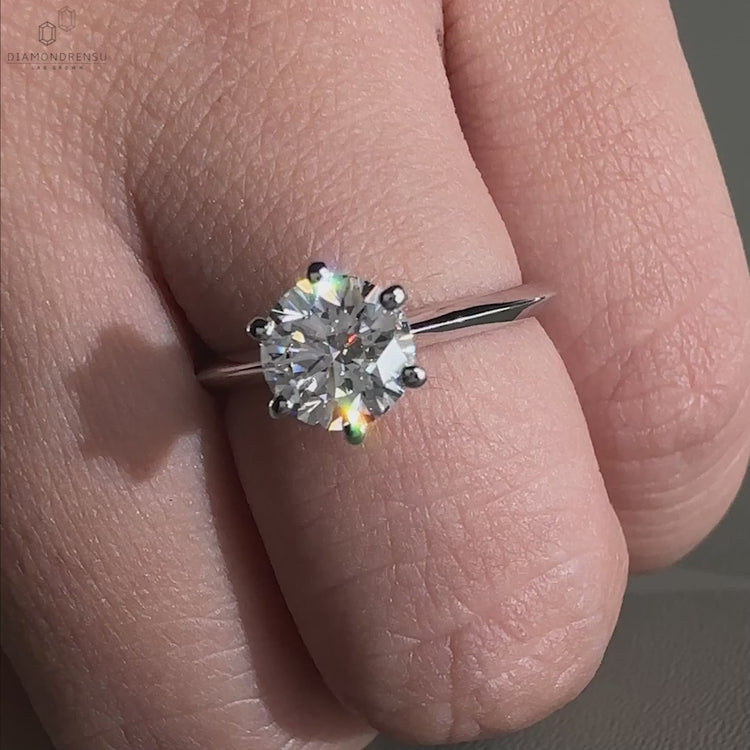 Diamond ring UK featuring a knife edge shank and a round diamond engagement ring style for timeless charm.

