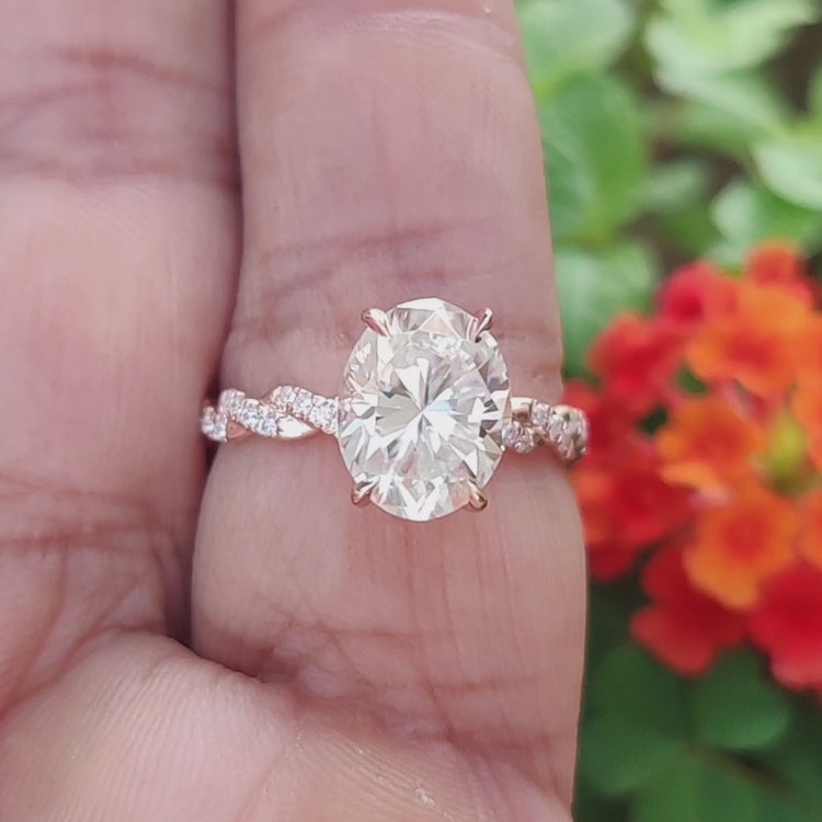 Elegant rose gold ring with oval moissanite and under halo styling.
