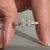 Radiant diamond engagement ring featuring pave set band and round diamond pave band.
