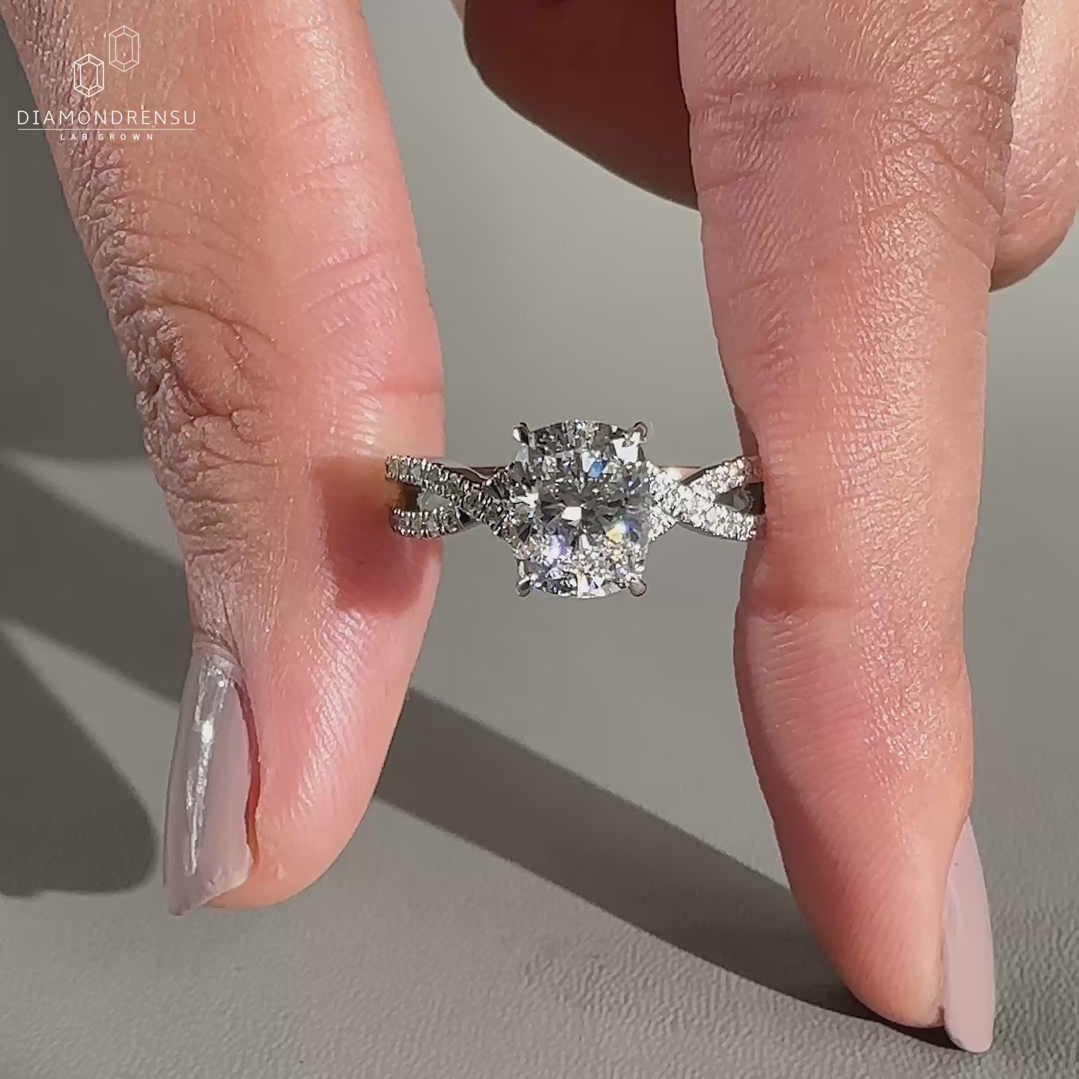 Twisted pavé band paired with an elongated cushion cut diamond.
