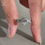 Twisted pavé band paired with an elongated cushion cut diamond.
