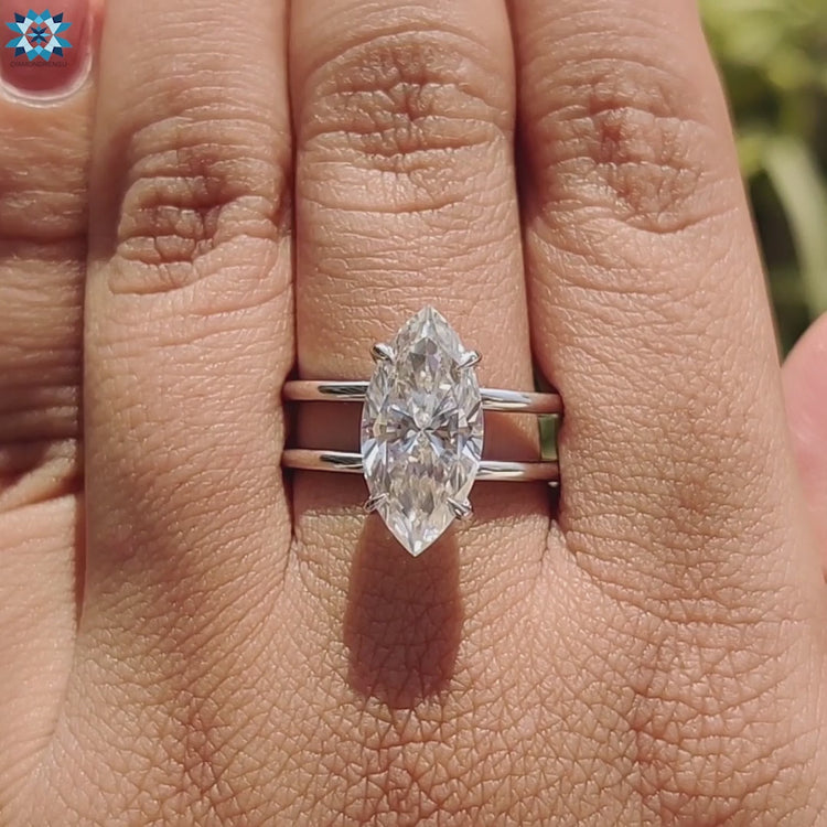 Elegant white gold ring with marquise moissanite centerpiece.
