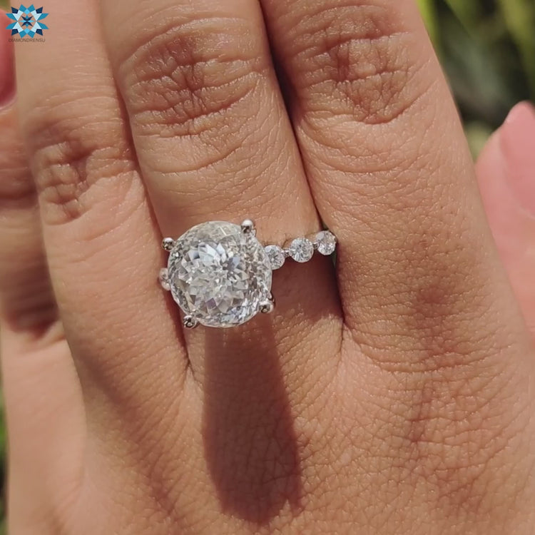 Moissanite ring with Portuguese cut and pave setting, set in white gold.
