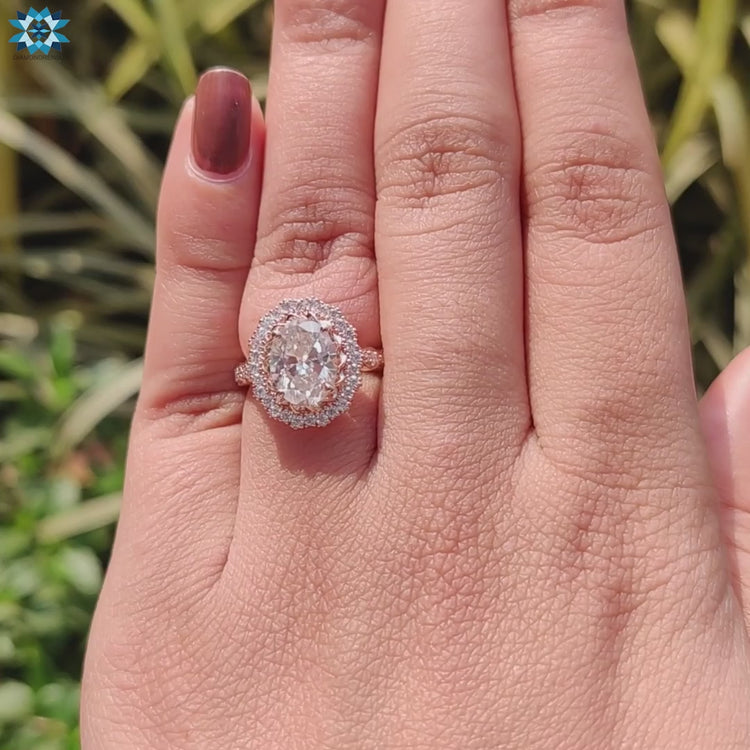 Pave engagement ring with round cut halo stones.

