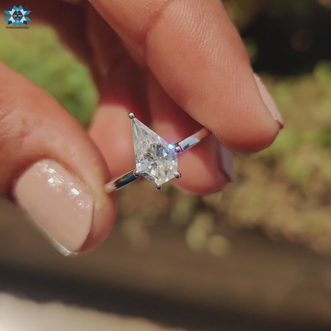 Spear cut moissanite ring crafted in white gold with handmade detail.
