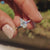Spear cut moissanite ring crafted in white gold with handmade detail.
