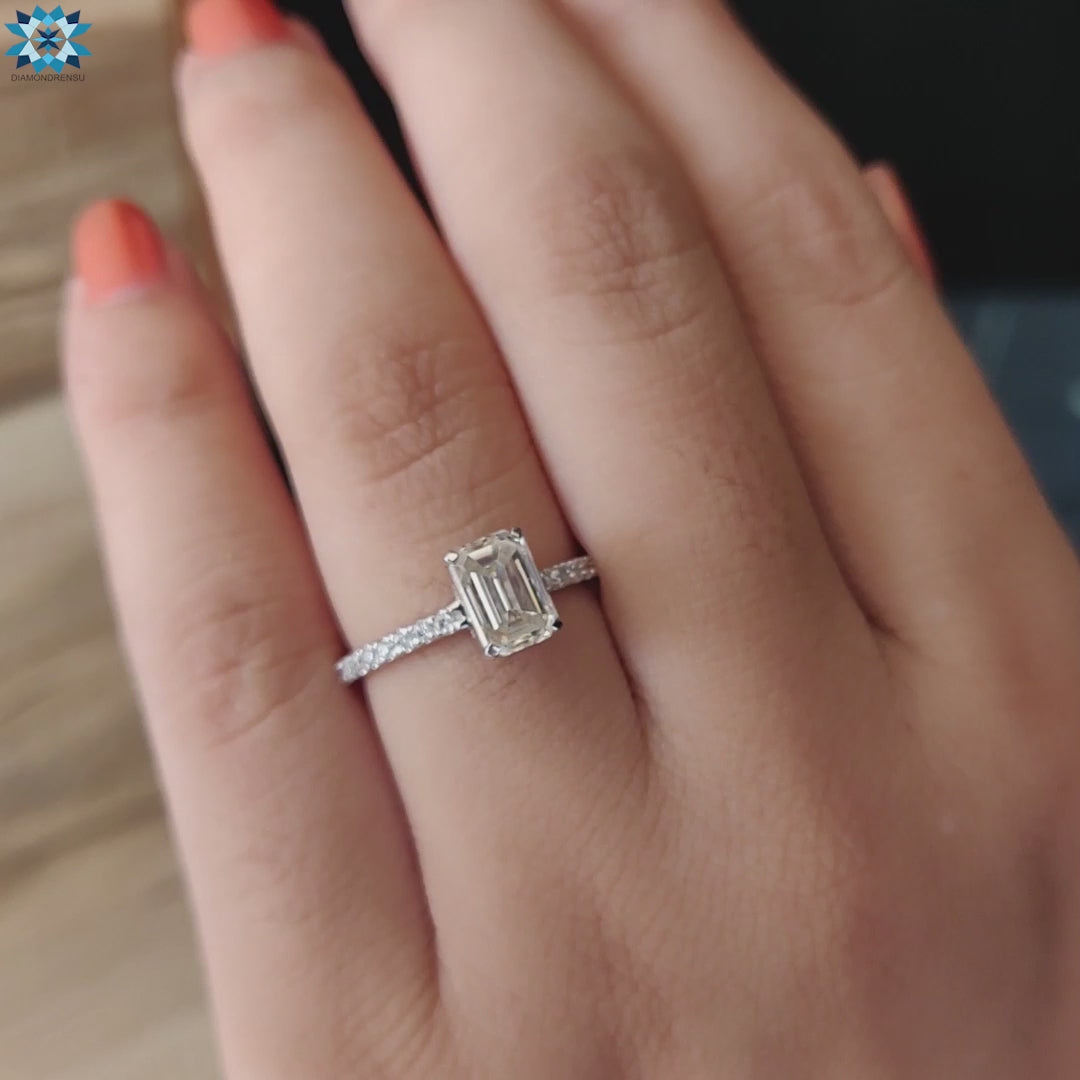 Moissanite pave ring in white gold with hidden halo and emerald cut stone.