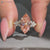 Marquise diamond ring with round side stones.
